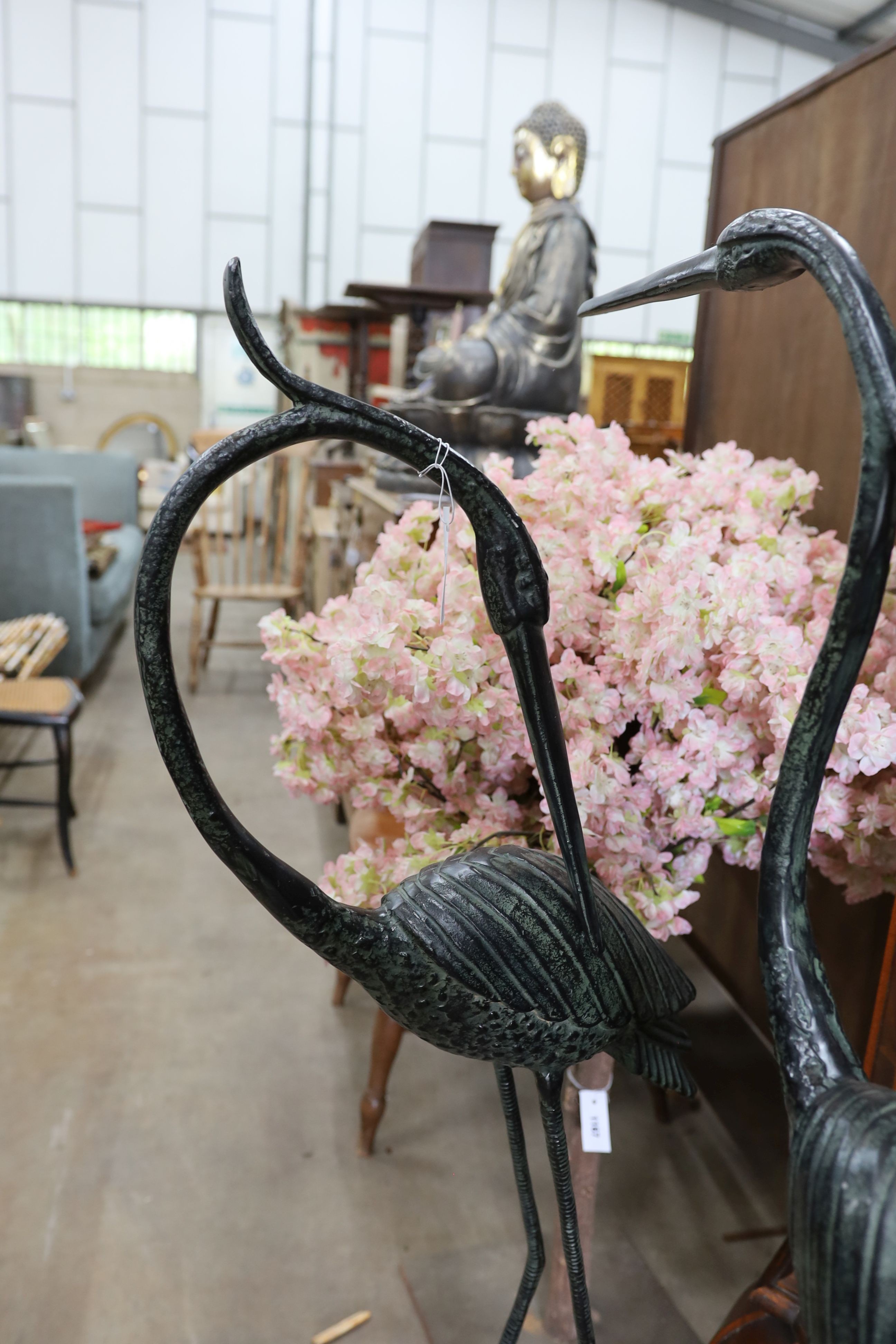 A pair of bronzed metal crane garden ornaments, larger height 136cm